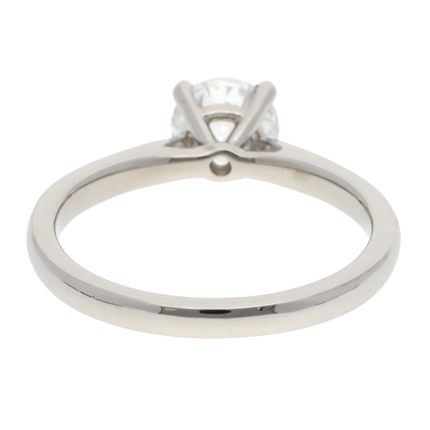 A solitaire brilliant cut diamond ring in platinum, on a white background