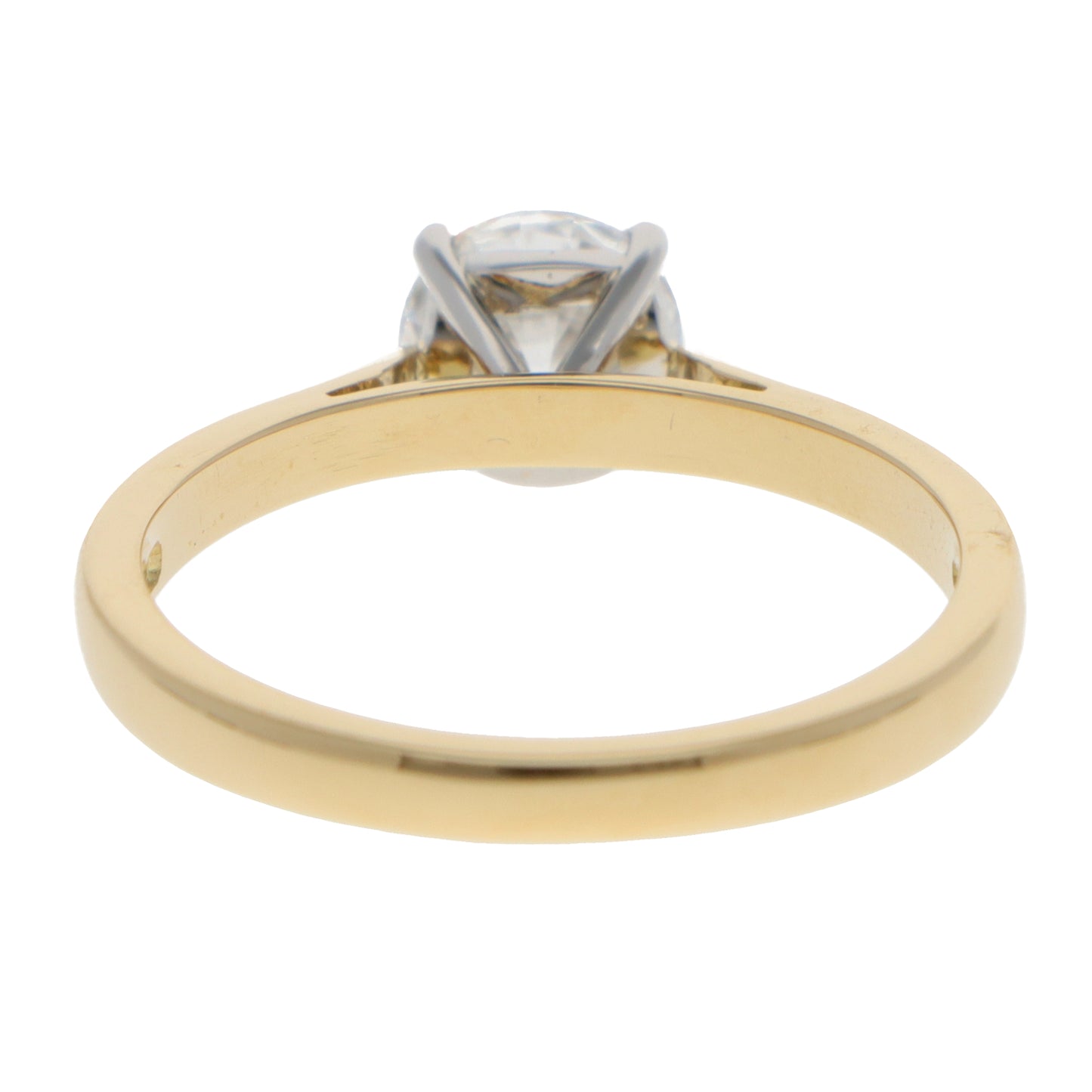 A yellow gold and platinum solitaire brilliant cut diamond ring, on a white background