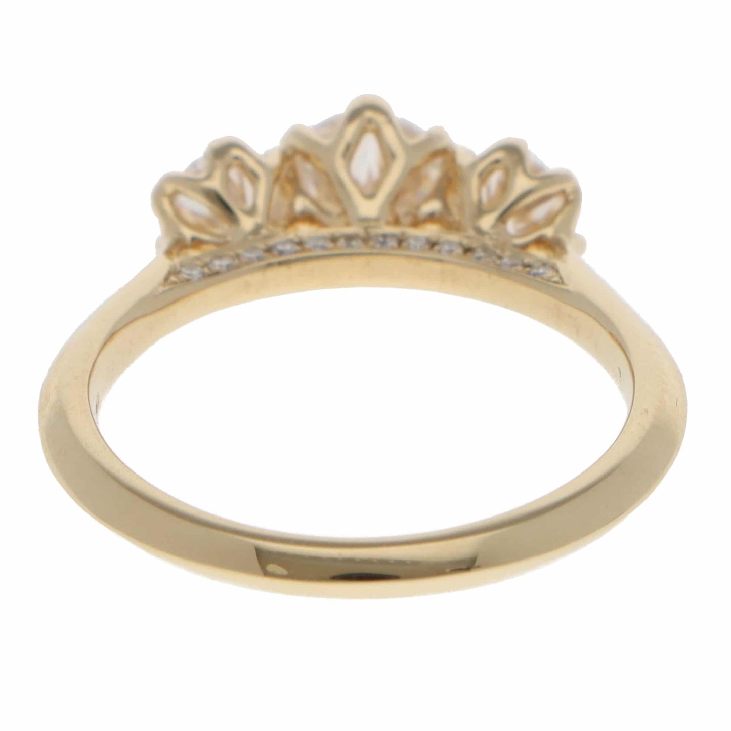 A three stone diamond ring in yellow gold, on a white background