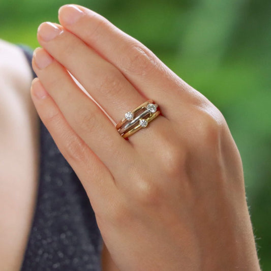 Diamond triple ring set in yellow, white and rose gold.