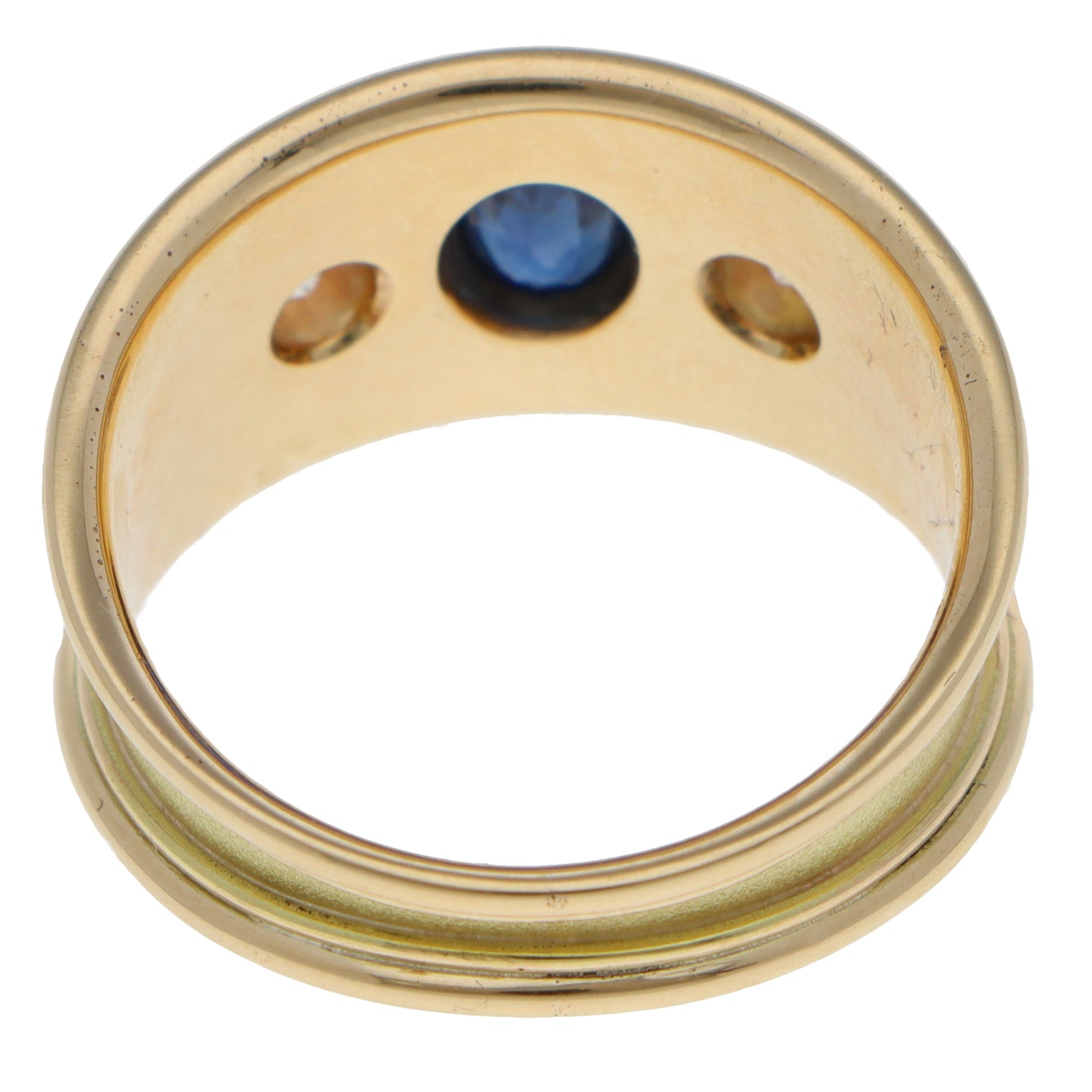 A yellow gold three stone band ring on a white background