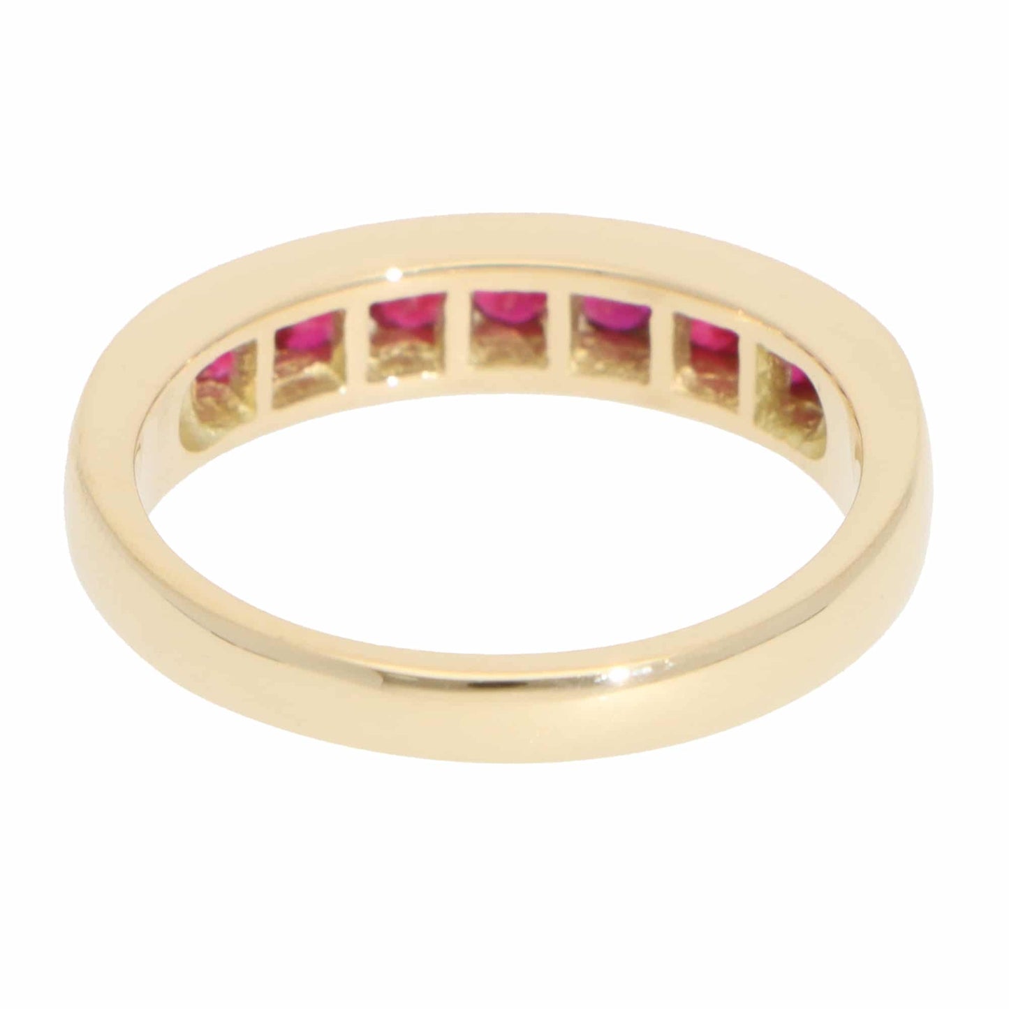 A yellow gold half eternity band with round rubies, on a white background