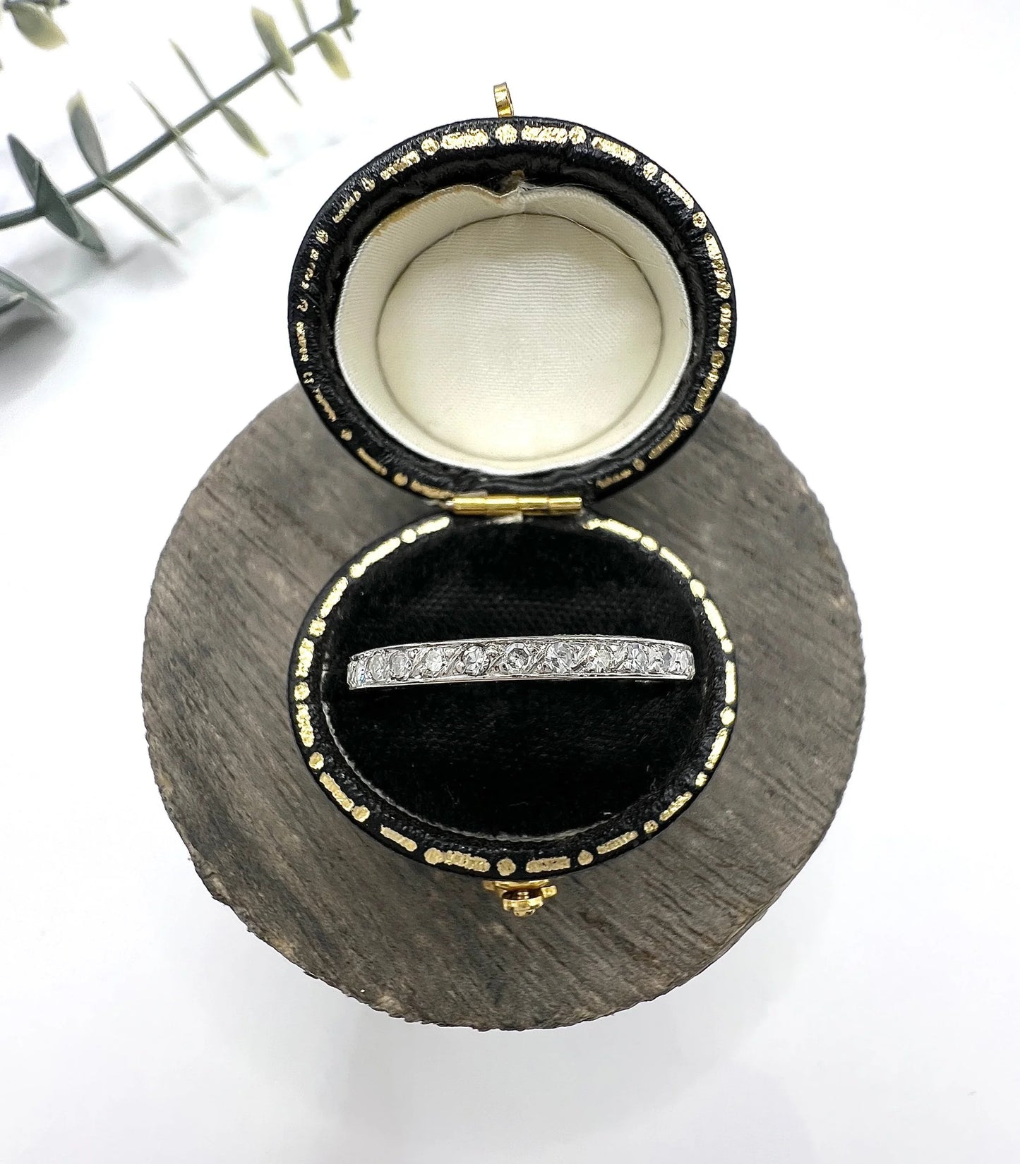 A platinum and diamond full eternity band ring, in a ring box