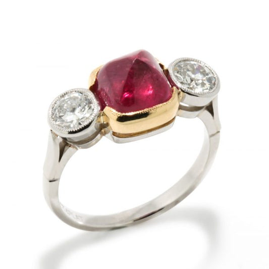 Art Deco Natural Cabochon Ruby and Diamond Trilogy Ring; central 4.52ct cabochon-cut natural ruby flanked by 1cts old-cut diamonds, in 18ct yellow gold and platinum, Circa 1920, with GCS certificate