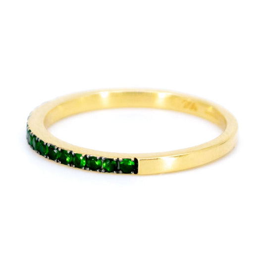 A green garnet half eternity band ring in yellow gold