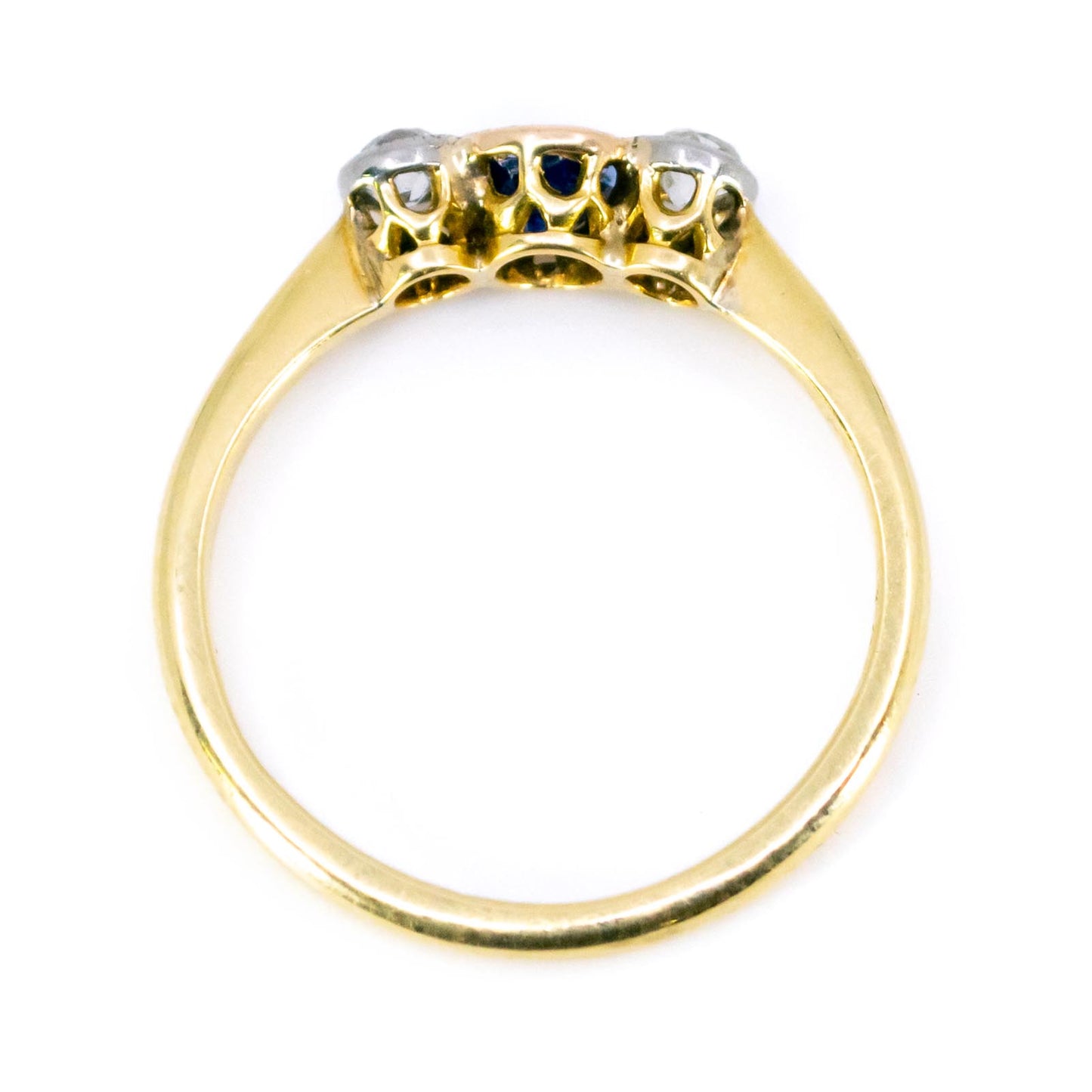 A three stone sapphire and diamond ring in yellow and white gold