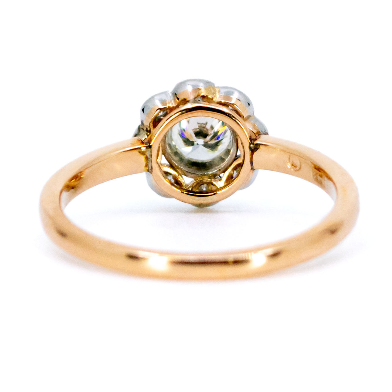A round diamond cluster ring in gold and platinum