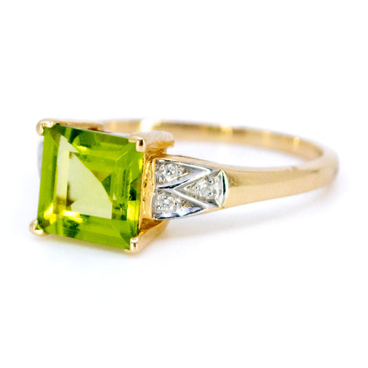 A square peridot ring with diamond shoulders in yellow and white gold