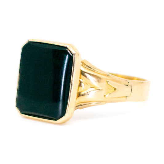 A black onyx signet ring in yellow gold