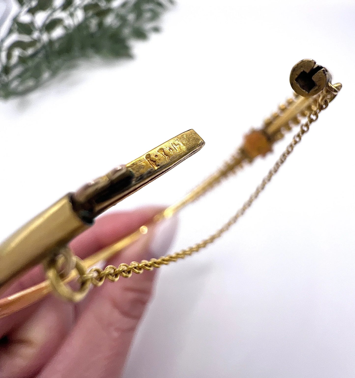 Close-up of a 9CT stamp on a yellow gold bangle clasp