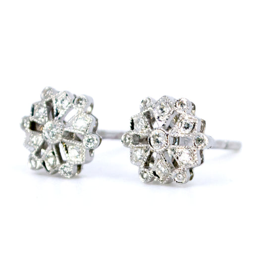 A pair of diamond snowflake design stud earrings in white gold