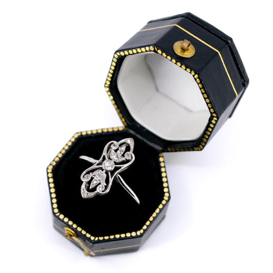 A diamond elongated ring in platinum, in a ring box