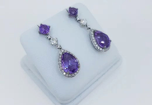 Amethyst and Diamond Pear Shaped Cluster Drop Earrings; pear-shaped rose-cut amethyst and diamond cluster suspended by an amethyst stud, via a brilliant cut diamond. Mounted in 18ct white gold.