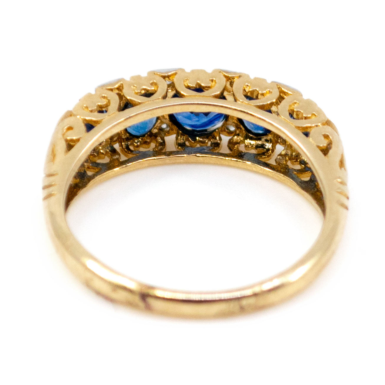 A yellow and white gold half hoop ring with sapphires and diamonds