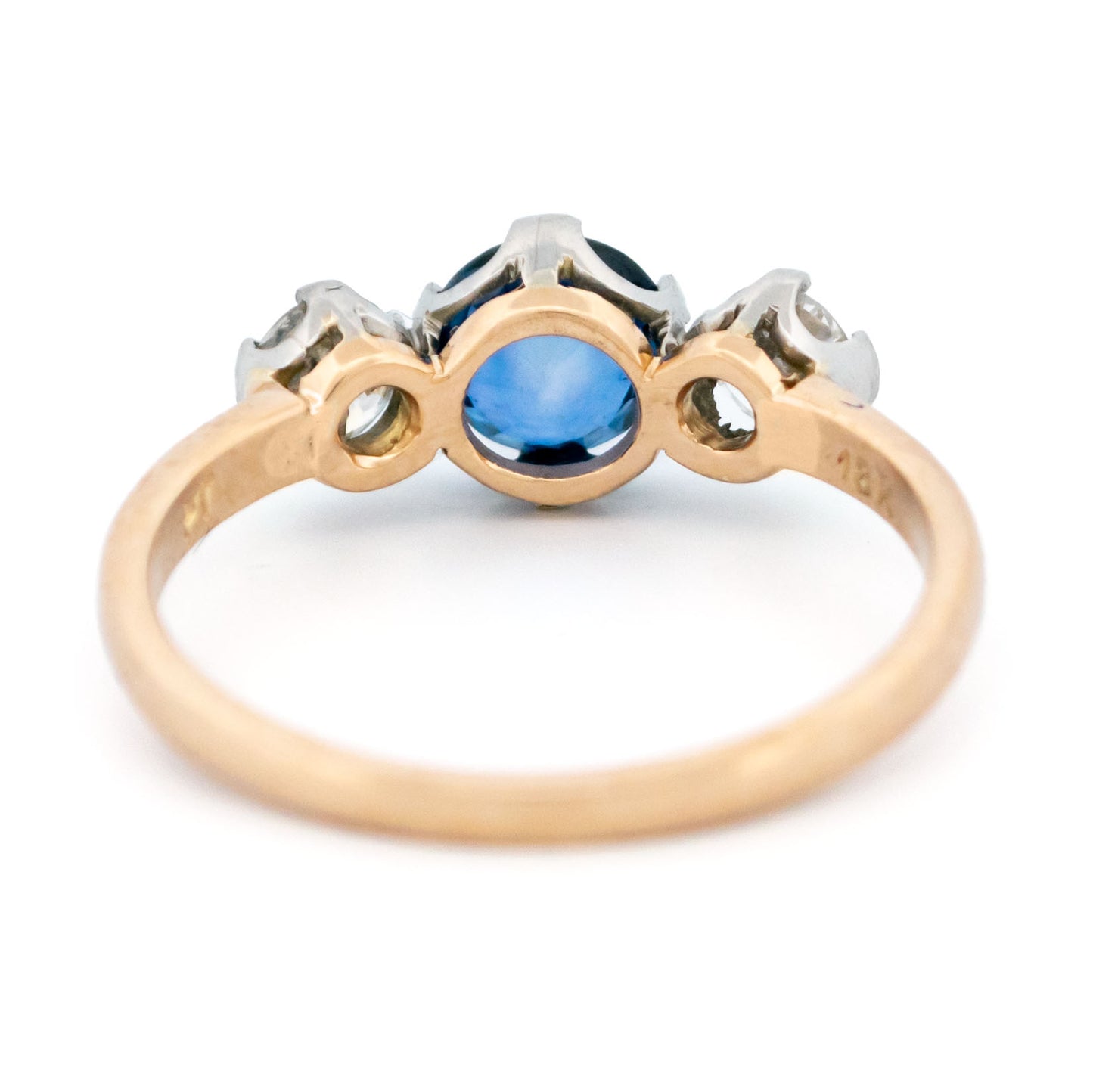 A three stone sapphire and diamond ring in yellow and white gold