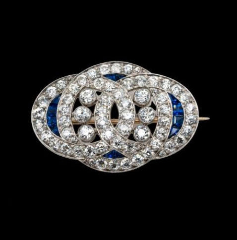 Art Deco Sapphire and Old Cut Diamond Brooch in Platinum; 4cts old European cut diamonds and 0.20cts natural sapphires, in platinum with intricate engraved edges, Circa 1920