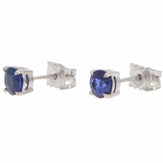 A pair of blue sapphire single stone stud earrings in white gold, on a white background