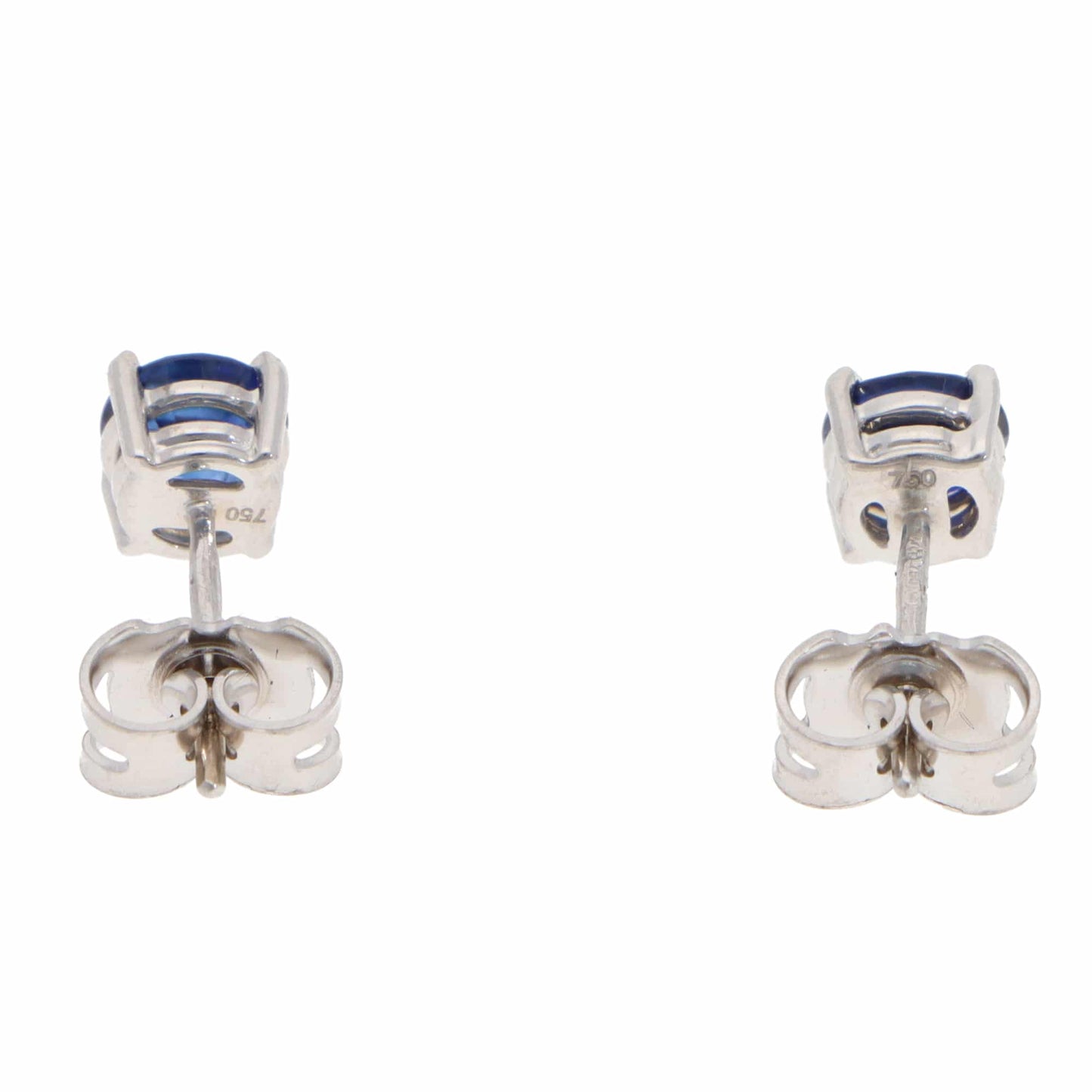 A pair of blue sapphire single stone stud earrings in white gold, on a white background