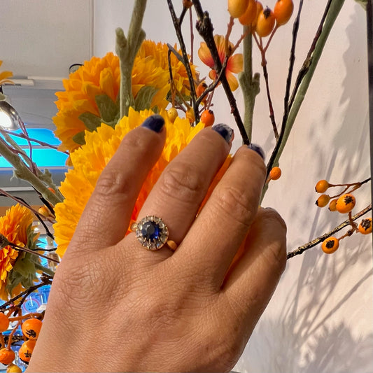 A sapphire and rose cut diamond ring in yellow gold, modelled on a hand
