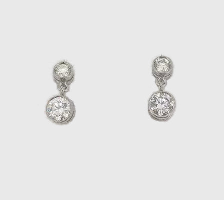 Diamond Drop Earrings; each earring comprising of two collet-set round brilliant-cut diamonds, 1.00 carat total. Mounted in 18ct white gold.