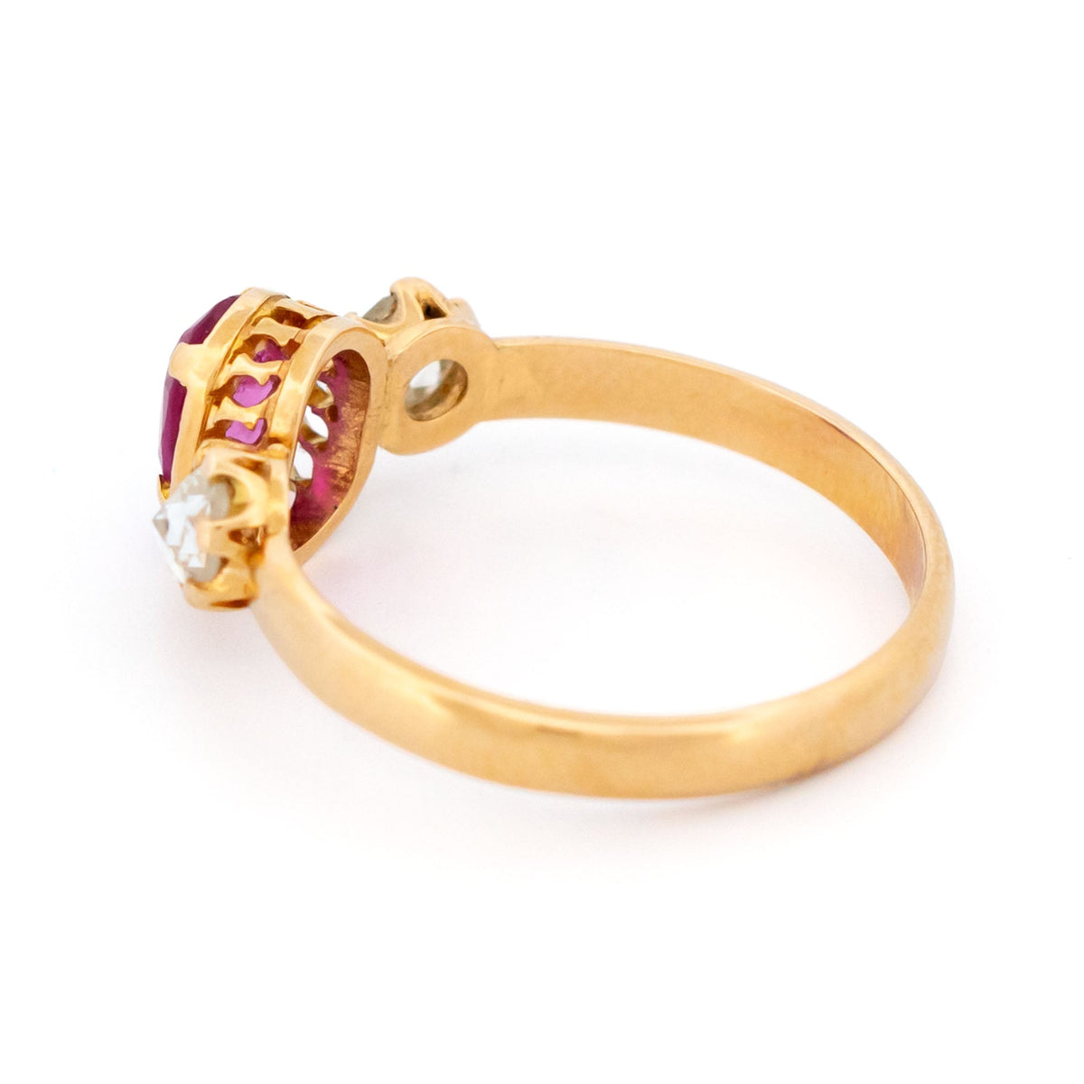 A three stone oval ruby and rose cut diamond ring in yellow gold