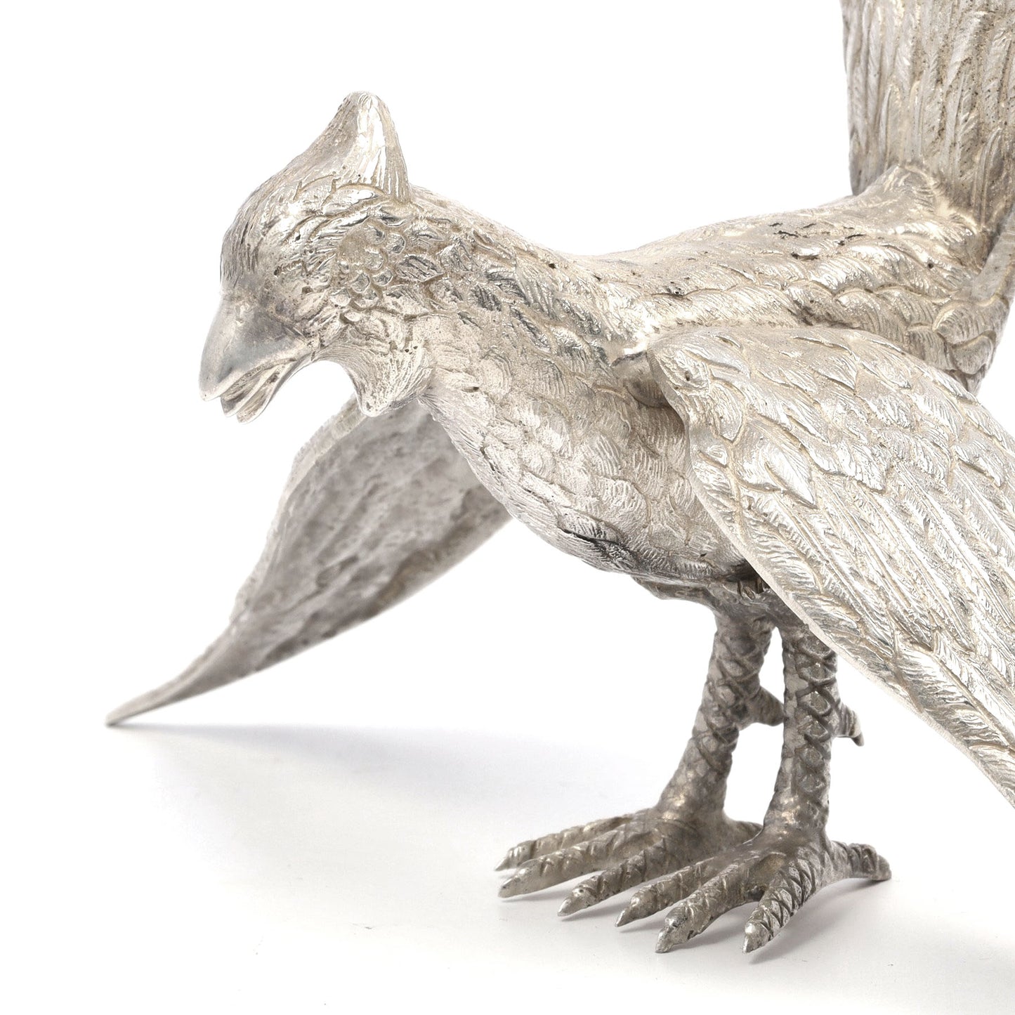 Silver bird figurine on a white background