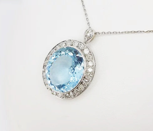 Aquamarine and Diamond Oval Cluster Pendant, 26.00 carats, mounted in 18ct white gold.