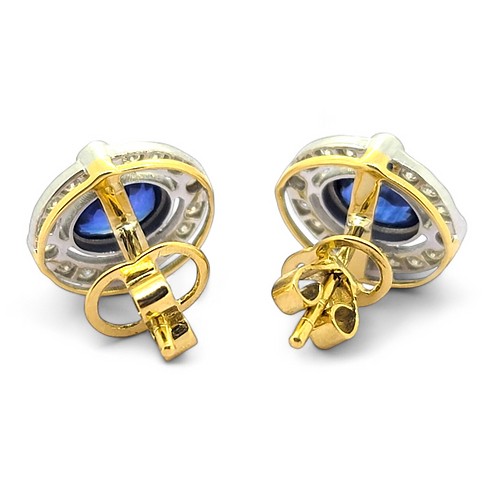 A pair of oval sapphire and round diamond cluster earrings in yellow and white gold