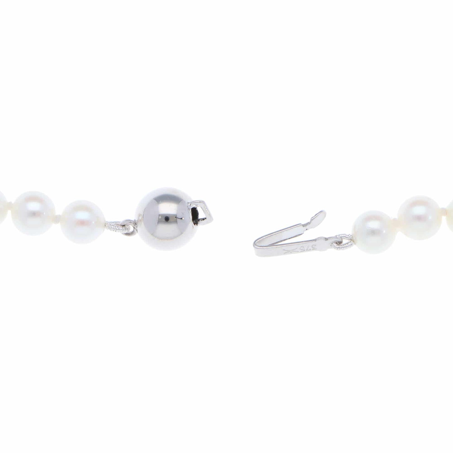 A white pearl single row necklace with a white gold clasp, on a white background