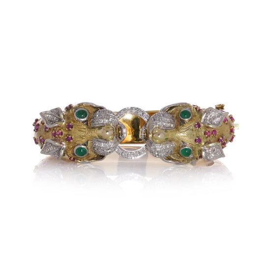 Larry dragon head gold bangle with diamonds, emeralds, and rubies.