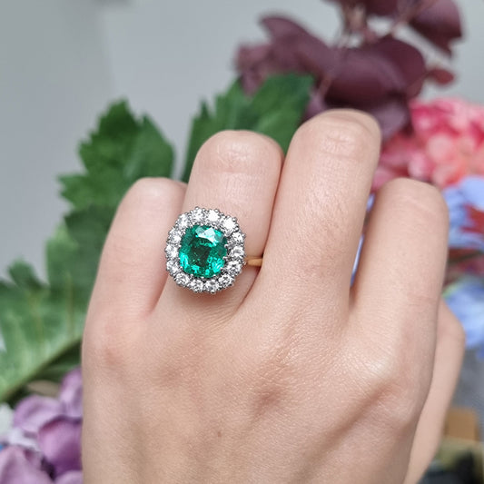 Vintage 2ct Emerald and Diamond Cluster Engagement Ring, 2ct cushion-cut emerald surrounded by 0.84cts round brilliant-cut diamonds in 18ct gold