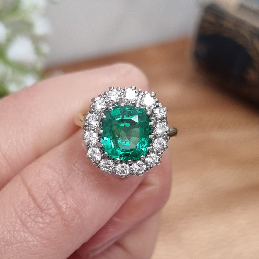 Vintage 2ct Emerald and Diamond Cluster Engagement Ring, 2ct cushion-cut emerald surrounded by 0.84cts round brilliant-cut diamonds in 18ct gold