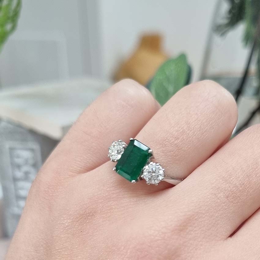 Emerald Cut Emerald and Diamond Three Stone Ring in 18ct White Gold