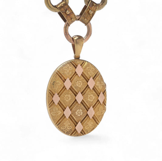 An antique yellow and rose gold fancy link necklace with an oval locket pendant, on a white background