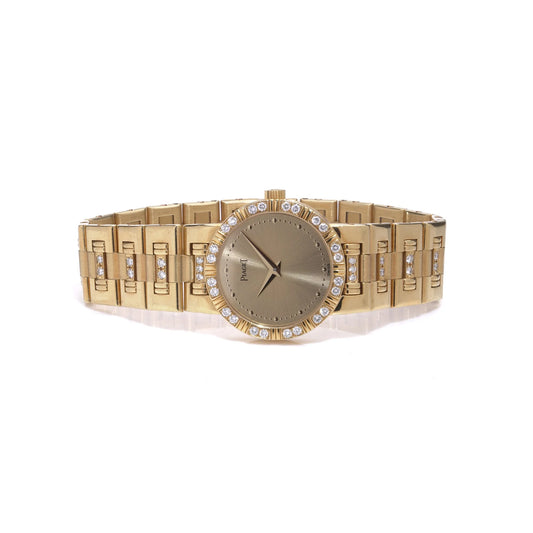 A ladies Piaget yellow gold and diamond wristwatch with champagne coloured dial, on a white background
