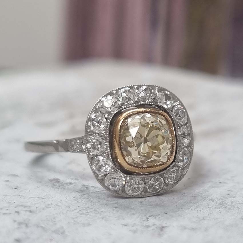 Antique 1.17ct Old Mine Cut Yellow Diamond Cluster Engagement Ring in Platinum, 1.17ct old mine-cut yellow diamond surrounded by halo of white diamonds