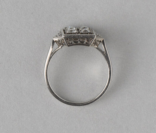 Art Deco French 0.70ct Old Cut Diamond and Platinum Square Ring; four old cut diamonds, flanked by diamond-set triangle shoulders, Numbered, Circa 1920