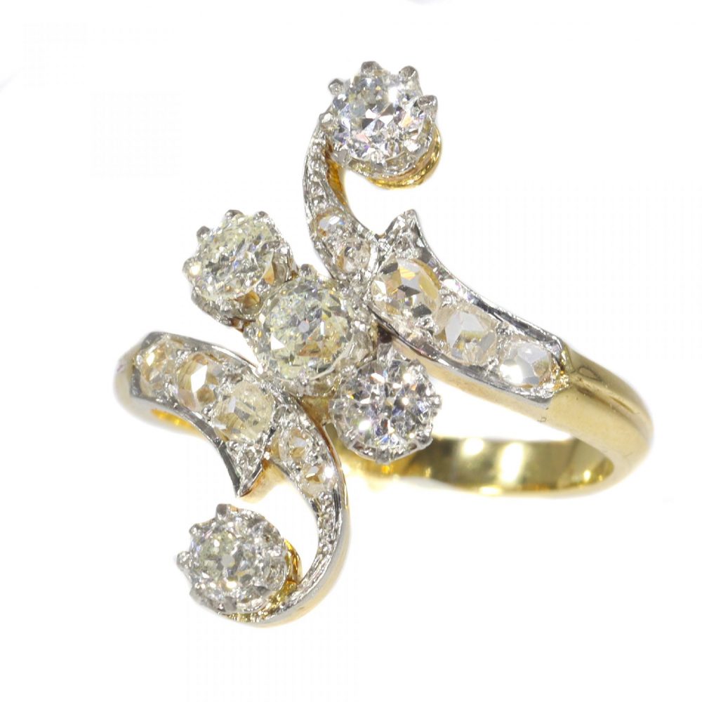 Belle Epoque Old Cut Diamond Crossover Ring, set with 1.04cts old cut diamonds accented with rose cut diamonds, in platinum and 18ct yellow gold, Circa 1910