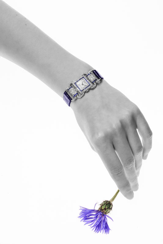 A ladies Art Deco design cocktail wristwatch set with diamonds and sapphires, on a blue leather strap, modelled on a wrist