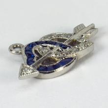 Sapphire, Diamond and Platinum Interlocking Hearts and Cupids Arrow Charm Pendant; platinum charm pendant designed as a pair of interlocking hearts set with 0.12cts white diamonds and 0.15cts blue sapphires, connected by Cupid’s arrow