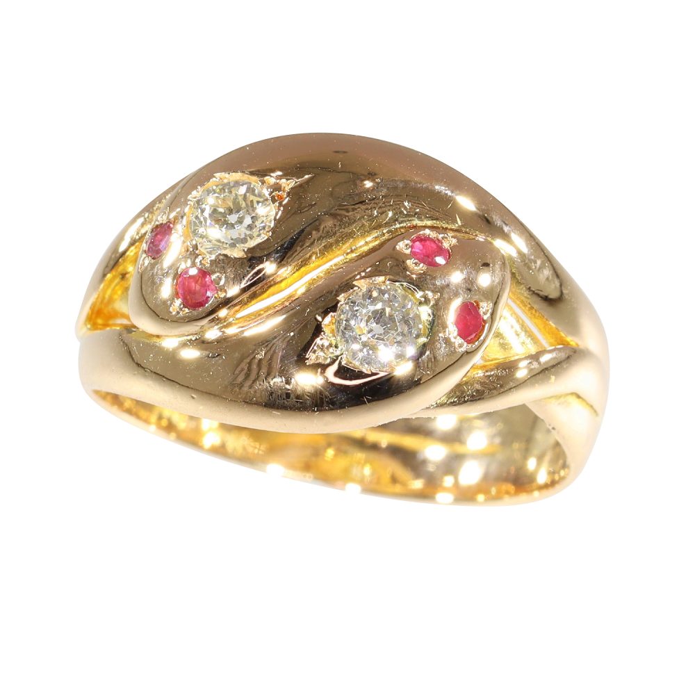 Snake ring with diamonds and rubies in gold.
