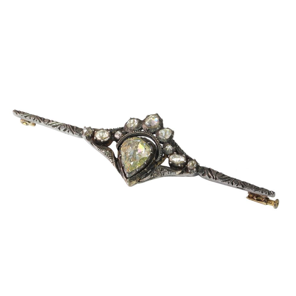 Diamond bar brooch in gold and silver.