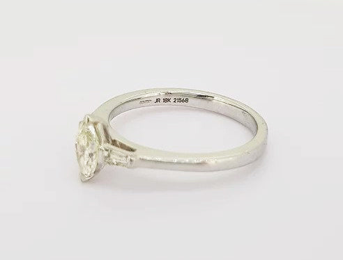 Marquise Cut Diamond Engagement Ring; set with a 0.45ct marquise-cut diamond flanked by 0.13ct baguette-cut diamond set shoulders, 18ct white gold.