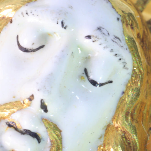An enamelled face of Christ on a banded agate and yellow gold wirework pendant