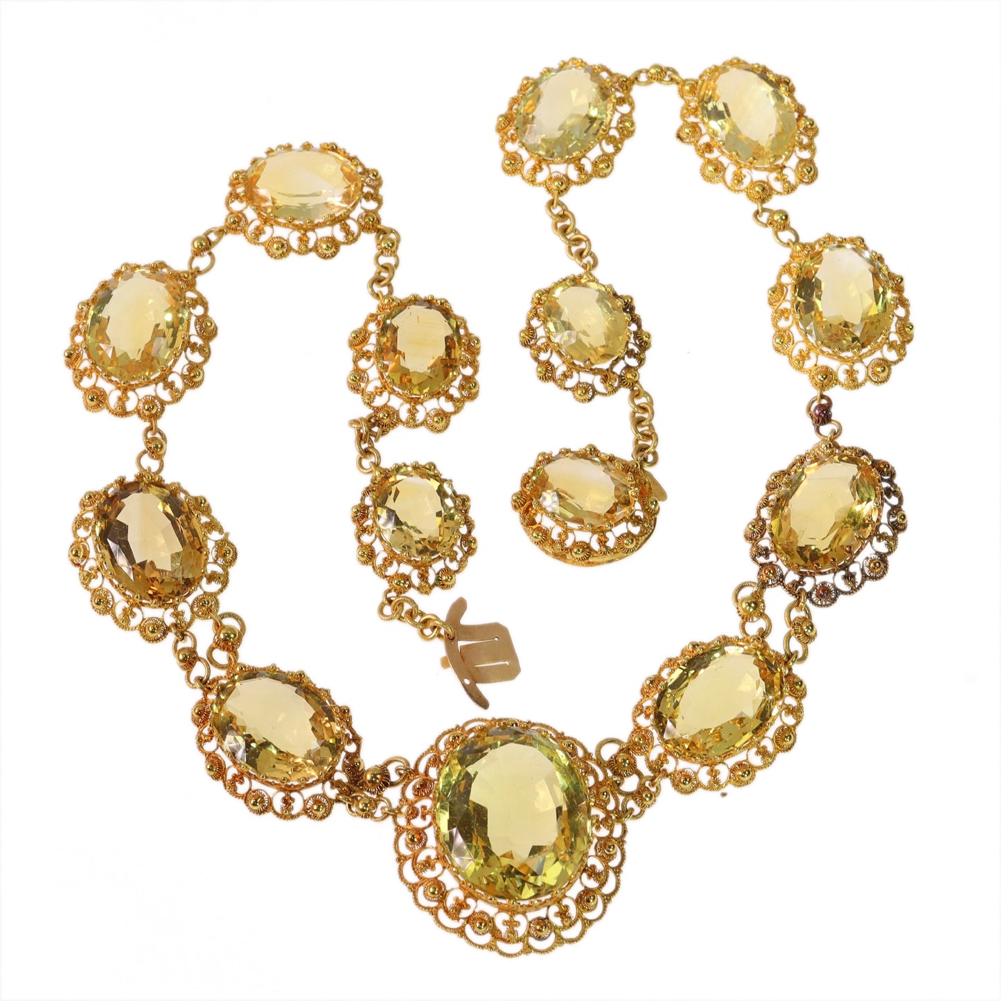 An intricate yellow gold necklace set with oval citrines in filigree mounts