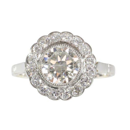 A brilliant cut diamond scalloped edge cluster ring in platinum