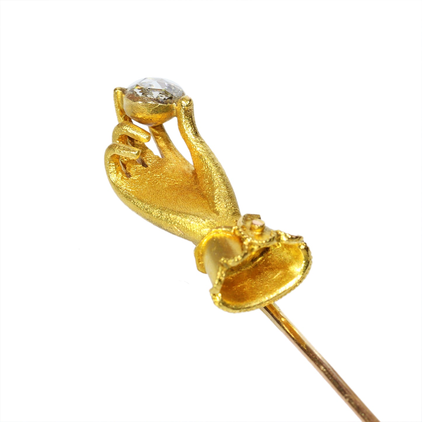 A yellow gold hand holding a diamond stick or tie pin