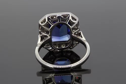 Tanzanite and Diamond Cluster Dress Tablet Ring; central bezel-set 4.50ct emerald-cut tanzanite surrounded by 0.80cts pave-set diamonds, in 18ct white gold