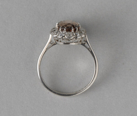 Antique Edwardian Zircon, Old Cut Diamond and Platinum Oval Cluster Ring; 2.27ct brown oval faceted zircon surrounded by 0.89cts old cut diamonds