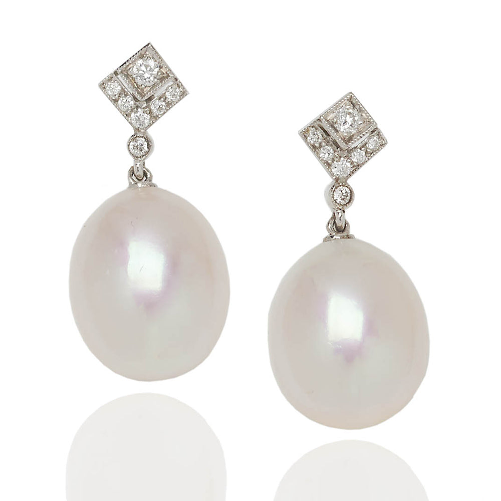 Diamond topped pearl drop earrings in 18 carat white gold.